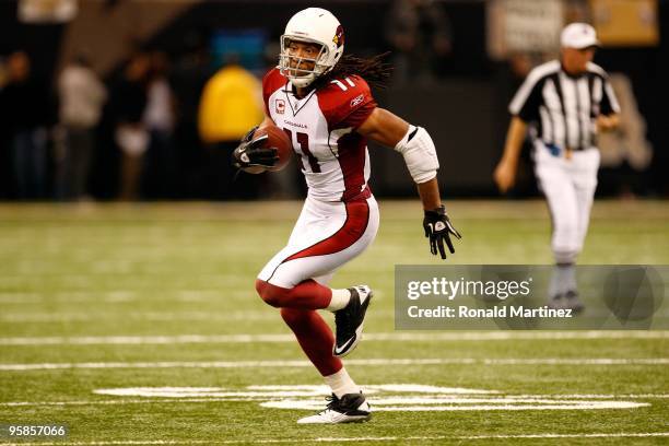 Larry Fitzgerald of the Arizona Cardinals runs for yards after the catch against the New Orleans Saints during the NFC Divisional Playoff Game at...