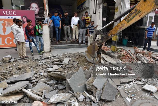 Municipal Corporation of Delhi officials demolish encroachments during an anti-encroachment drive at Kohat Enclave on May 14, 2018 in New Delhi,...