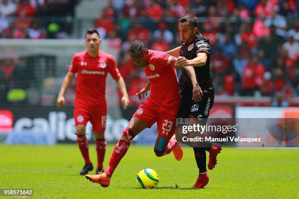 Luis Quiñones of Toluca struggles for the ball against Omar Mendoza of Tijuana during the semifinals second leg match between Toluca and Tijuana as...