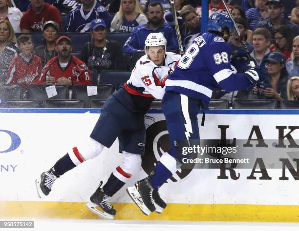 Andre Burakovsky of the Washington Capitals and Mikhail Sergachev of the Tampa Bay Lightning collide on the boards in Game Two of the Eastern...