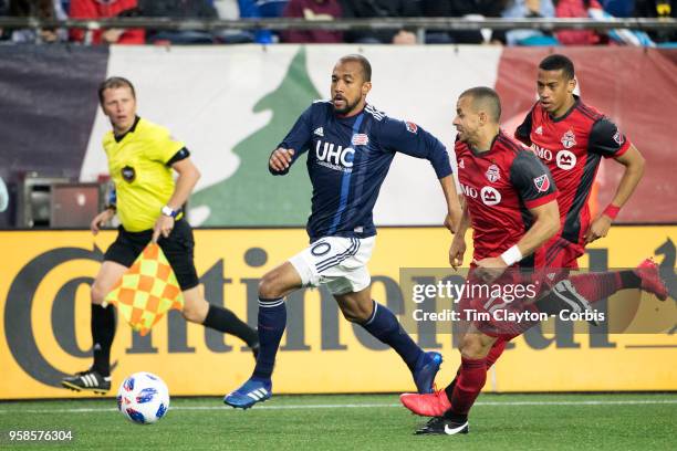 May 12: Teal Bunbury of New England Revolution challenged by Jason Hernandez of Toronto FC during the New England Revolution Vs Toronto FC regular...