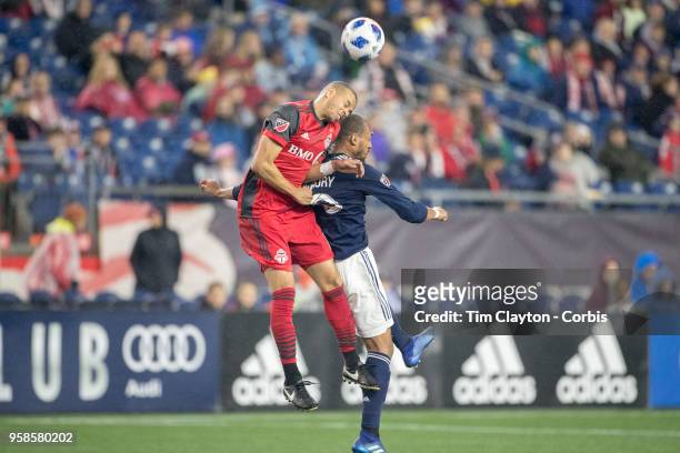 May 12: Jason Hernandez of Toronto FC and Teal Bunbury of New England Revolution challenge for the ball during the New England Revolution Vs Toronto...