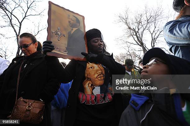 Barbara Jones, left, stands next to Bridget Johnson as she prays during the Martin Luther King Day parade on January 18, 2010 in Denver, Colorado....