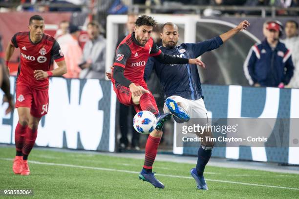 May 12: Jonathan Osorio of Toronto FC and Teal Bunbury of New England Revolution challenge for the ball during the New England Revolution Vs Toronto...