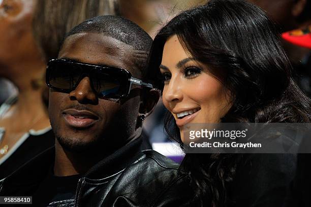 New Orleans Saints player Reggie Bush sits with Kim Kardashian on the court during the game between the San Antonio Spurs and the New Orleans Hornets...