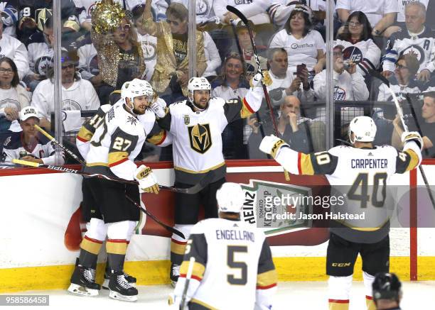 Tomas Tatar of the Vegas Golden Knights is congratulated by his teammates Shea Theodore, Ryan Carpenter and Pierre-Edouard Bellemare after scoring a...