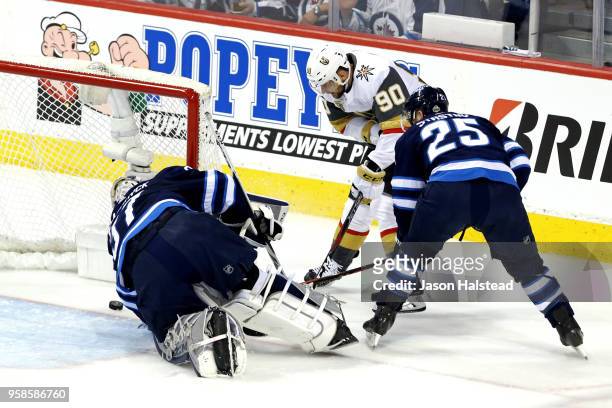 Paul Stastny defends as teammate Connor Hellebuyck of the Winnipeg Jets allows a first period goal to Tomas Tatar of the Vegas Golden Knights in Game...