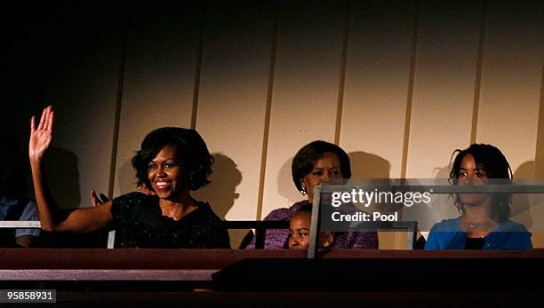 First lady Michelle Obama waves before U.S. President Barack Obama delivers remarks at the "Let Freedom Ring" concert at the Kennedy Center January...