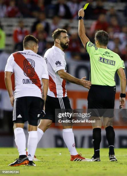 Referee Patricio Loustau shows a yellow card to Lucas Pratto of River Plate during a match between River Plate and San Lorenzo as part of Superliga...