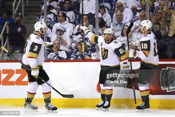 Jonathan Marchessault is congratulated by his teammates Brayden McNabb and Reilly Smith of the Vegas Golden Knights after scoring a first period goal...