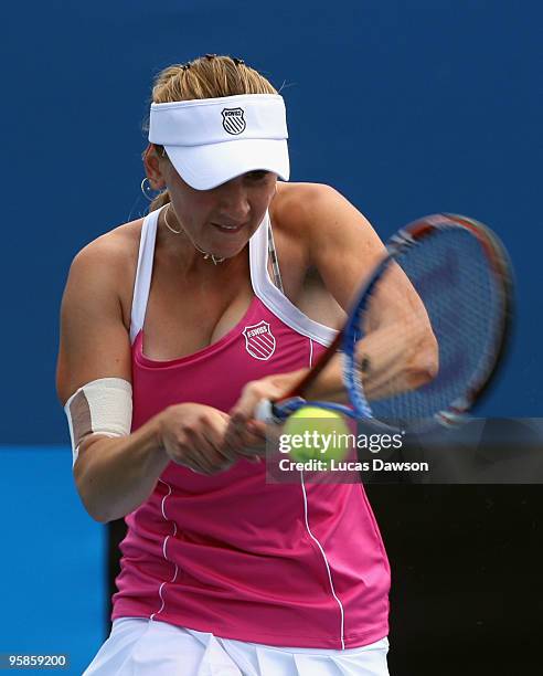 Olga Govortsova of Belarus plays a backhand in her first round match against Angelique Kerber of Germany during day two of the 2010 Australian Open...
