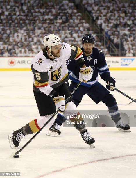 Colin Miller of the Vegas Golden Knights takes a shot under pressure from Mark Scheifele of the Winnipeg Jets during the first period in Game Two of...