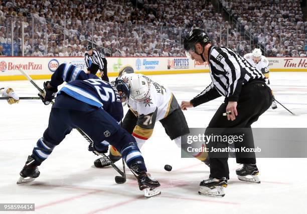 Mark Scheifele of the Winnipeg Jets take a first period face-off against William Karlsson of the Vegas Golden Knights in Game Two of the Western...