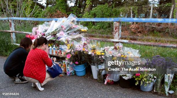 People offer flowers at where the body of 7-year-old Tamaki Omomo was found on May 14, 2018 in Niigata, Japan. A 23-year-old man was arrested in...