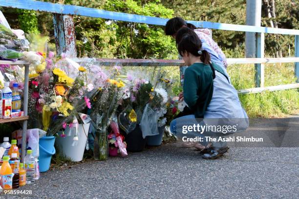 People offer flowers at where the body of 7-year-old Tamaki Omomo was found on May 14, 2018 in Niigata, Japan. A 23-year-old man was arrested in...