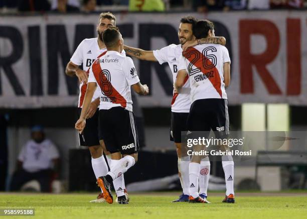 Ignacio Fernandez of River Plate celebrates with teammates Ignacio Scocco and Lucas Patto after scoring the opening goal during a match between River...