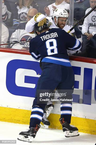 Jonathan Marchessault of the Vegas Golden Knights is checked into the boards by Jacob Trouba of the Winnipeg Jets during the first period in Game Two...