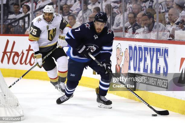 Ben Chiarot of the Winnipeg Jets is pursued by Ryan Reaves of the Vegas Golden Knights during the first period in Game Two of the Western Conference...