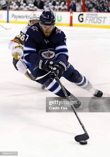 Ben Chiarot of the Winnipeg Jets is defended by Erik Haula of the Vegas Golden Knights during the first period in Game Two of the Western Conference...