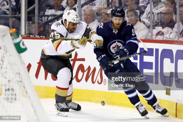 Kyle Connor of the Winnipeg Jets is checked by Ryan Reaves of the Vegas Golden Knights during the first period in Game Two of the Western Conference...