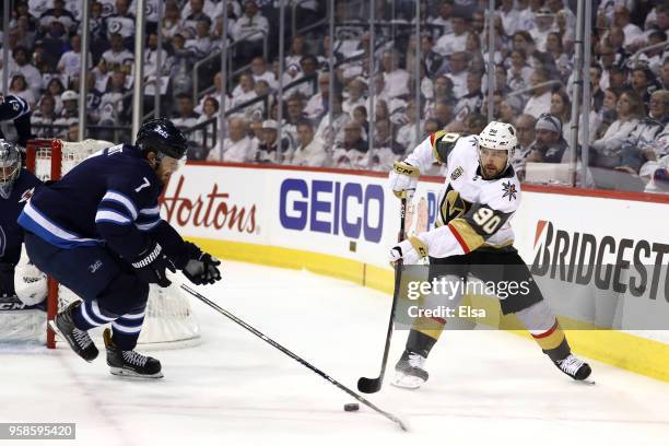 Tomas Tatar of the Vegas Golden Knights is defended by Ben Chiarot of the Winnipeg Jets during the first period in Game Two of the Western Conference...