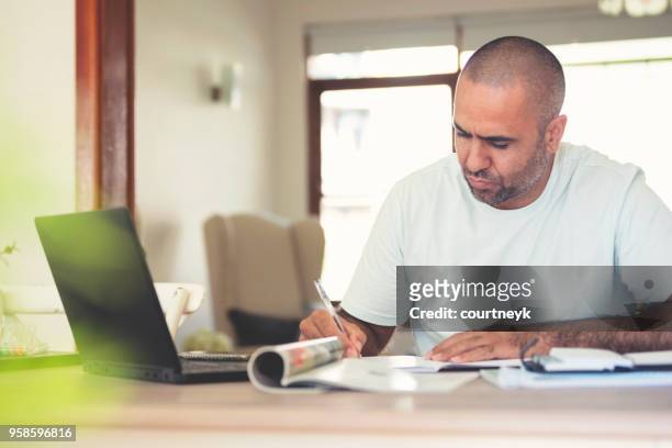 mature mean working at home. - aboriginal man stock pictures, royalty-free photos & images