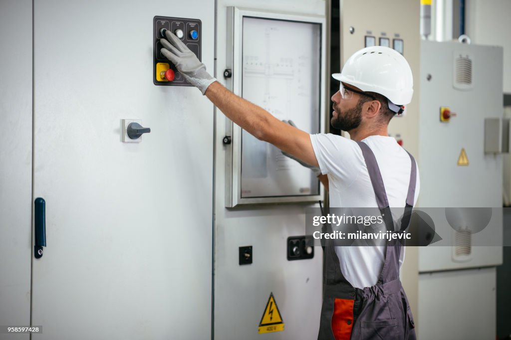 Industrial technician operating in electricity substation