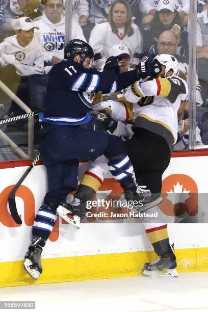 Adam Lowry of the Winnipeg Jets and Deryk Engelland of the Vegas Golden Knights collide during the second period in Game Two of the Western...