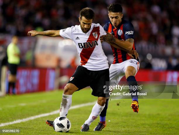 Leonardo Ponzio of River Plate fights for the ball with Gabriel Rojas of San Lorenzo during a match between River Plate and San Lorenzo as part of...