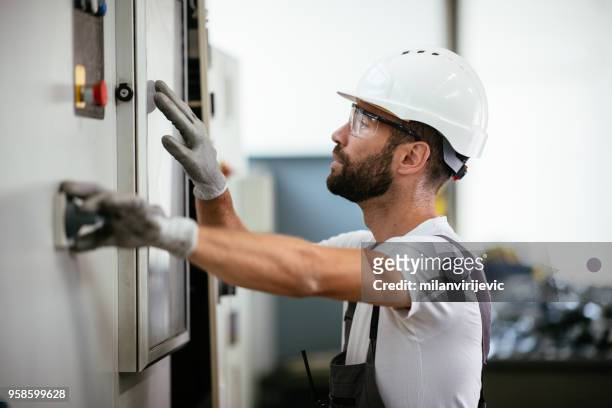 industrial technician operating in electricity substation - switch stock pictures, royalty-free photos & images