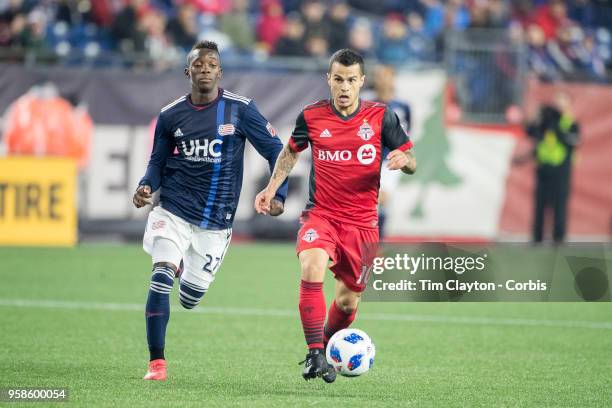 May 12: Sebastian Giovinco of Toronto FC challenged by Luis Caicedo of New England Revolution during the New England Revolution Vs Toronto FC regular...