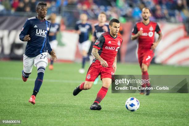 May 12: Sebastian Giovinco of Toronto FC challenged by Luis Caicedo of New England Revolution during the New England Revolution Vs Toronto FC regular...