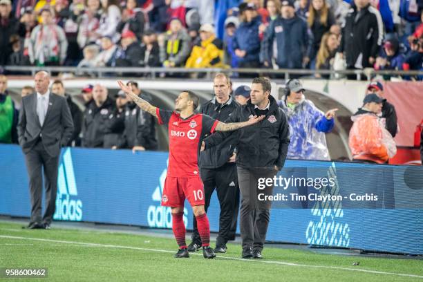 May 12: Toronto FC head coach Greg Vanney makes an effort to remove Sebastian Giovinco of Toronto FC from the field after his sending off during the...