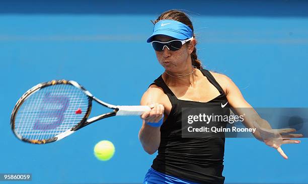 Rossana De Los Rios of Paraguay plays a forehand in her first round match against Marion Bartoli of France during day two of the 2010 Australian Open...