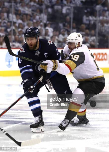 Patrik Laine of the Winnipeg Jets is defended by Reilly Smith of the Vegas Golden Knights during the second period in Game Two of the Western...