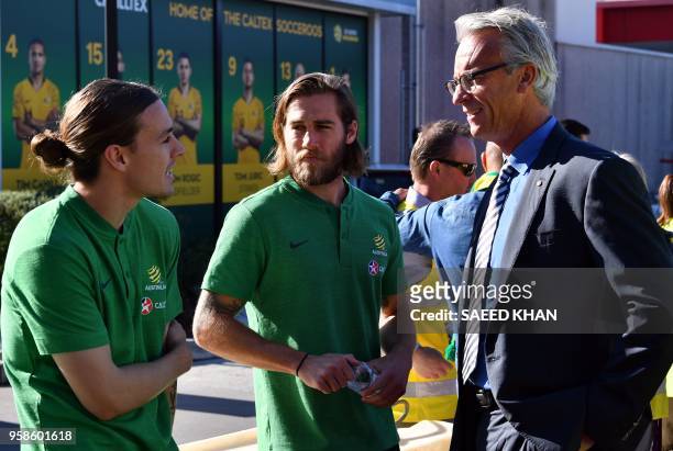 Australian football federation chief executive David Gallop talks to national team players Josh Brillante and Jackson Irvine during a media call in...