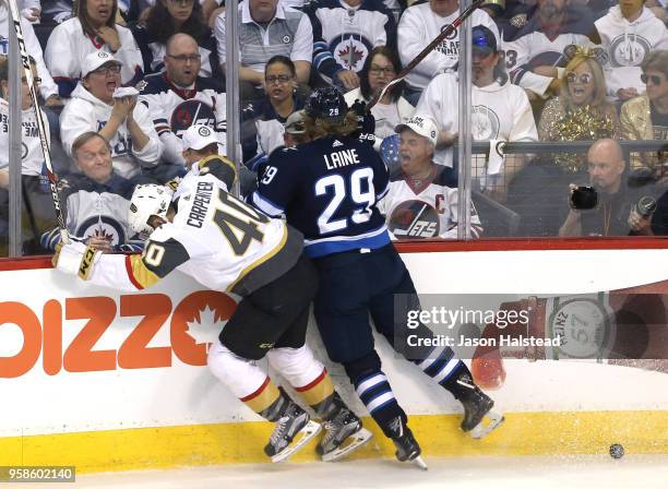 Ryan Carpenter of the Vegas Golden Knights is checked by Patrik Laine of the Winnipeg Jets during the second period in Game Two of the Western...