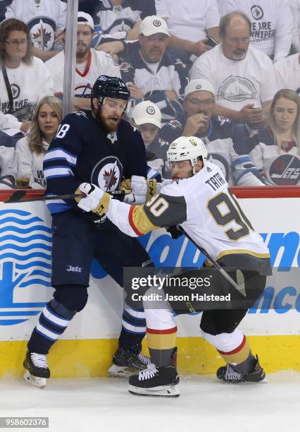 Bryan Little of the Winnipeg Jets and Tomas Tatar of the Vegas Golden Knights battle along the boards during the second period in Game Two of the...
