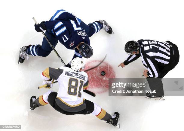 Adam Lowry of the Winnipeg Jets takes a second period face-off against Jonathan Marchessault of the Vegas Golden Knights in Game Two of the Western...