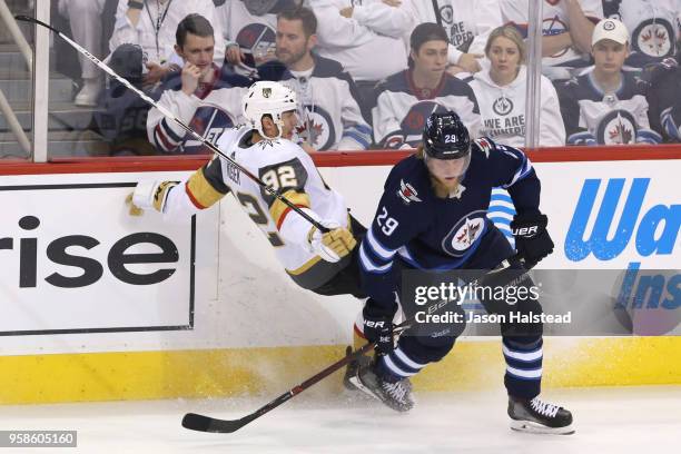 Tomas Nosek of the Vegas Golden Knights is checked by Patrik Laine of the Winnipeg Jets in during the third period Game Two of the Western Conference...
