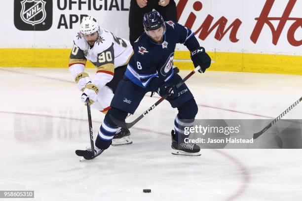 Tomas Tatar of the Vegas Golden Knights and Jacob Trouba of the Winnipeg Jets battle for the puck during the third period in Game Two of the Western...