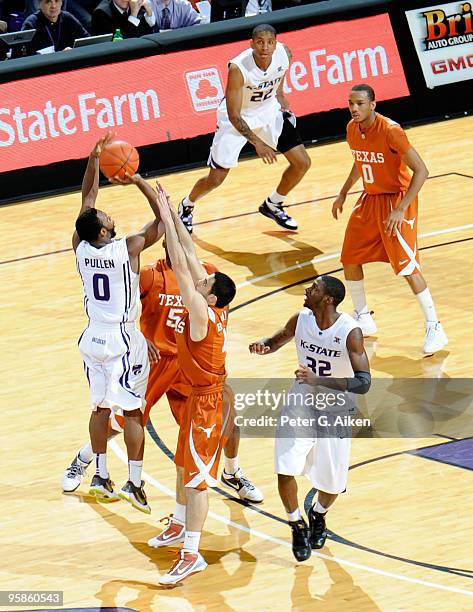 Guard Jacob Pullen of the Kansas State Wildcats puts up a three-point shot over pressure from defenders Dogus Balbay#4 and Damion James of the Texas...