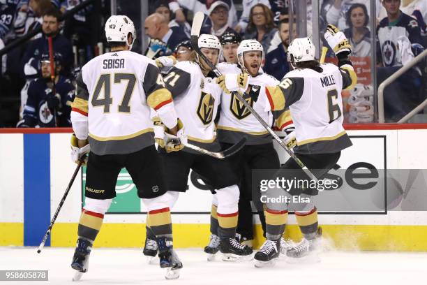 Jonathan Marchessault of the Vegas Golden Knights is congratulated by his teammates after scoring a third period goal against the Winnipeg Jets in...