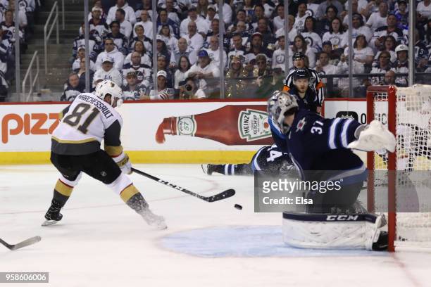 Jonathan Marchessault of the Vegas Golden Knights scores a third period goal past Connor Hellebuyck of the Winnipeg Jets during the third period in...