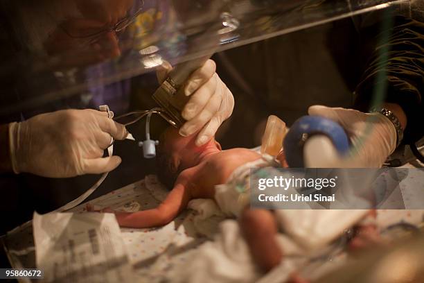 Israeli doctors give CPR to a premature baby born today at the Israeli army hospital January 18, 2010 in Port-au-Prince, Haiti. Humanitarian aid is...