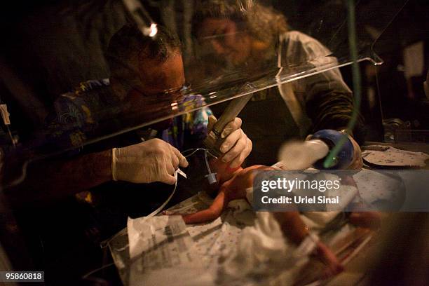 Israeli doctors give CPR to a premature baby born today at the Israeli army hospital January 18, 2010 in Port-au-Prince, Haiti. Humanitarian aid is...