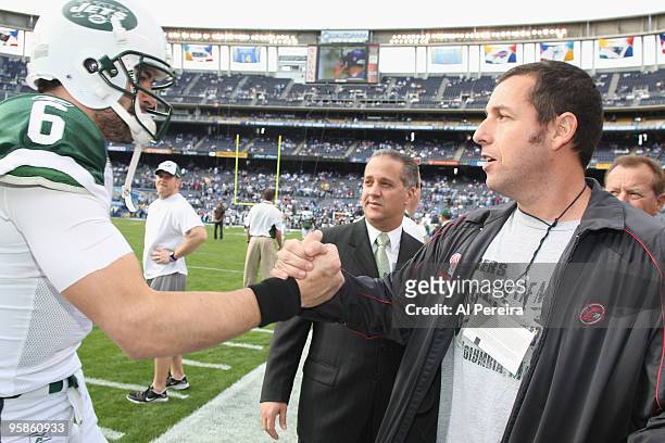 Actor Adam Sandler meets with Quarterback Mark Sanchez of the New York Jets on the sideline before the start of the AFC Divisional Playoff game...