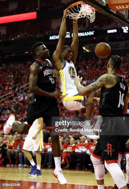 Kevon Looney of the Golden State Warriors dunks against Clint Capela of the Houston Rockets in the third quarter in Game One of the Western...