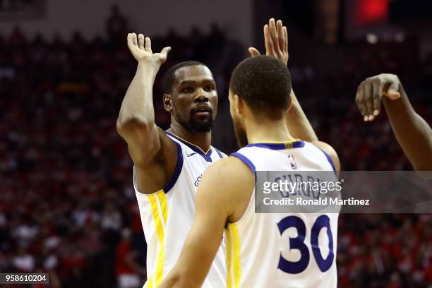 Kevin Durant and Stephen Curry of the Golden State Warriors react after a play in the third quarter against the Houston Rockets in Game One of the...