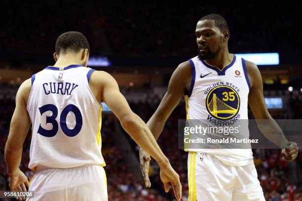Kevin Durant and Stephen Curry of the Golden State Warriors react after a play in the third quarter against the Houston Rockets in Game One of the...
